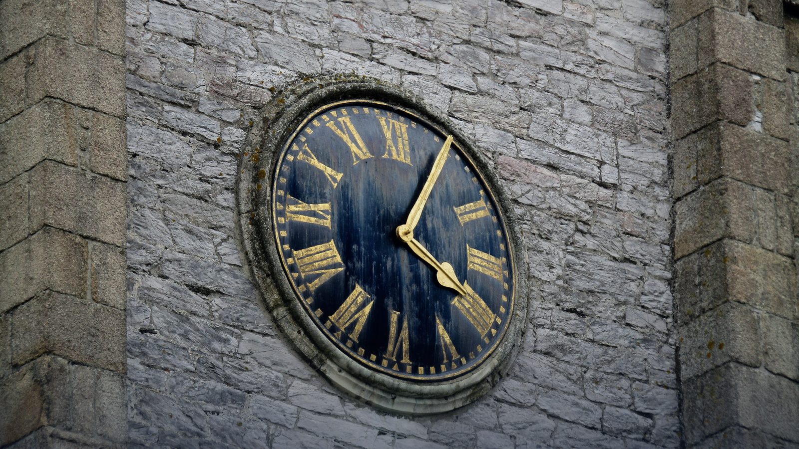 A close-up of a church tower clock face