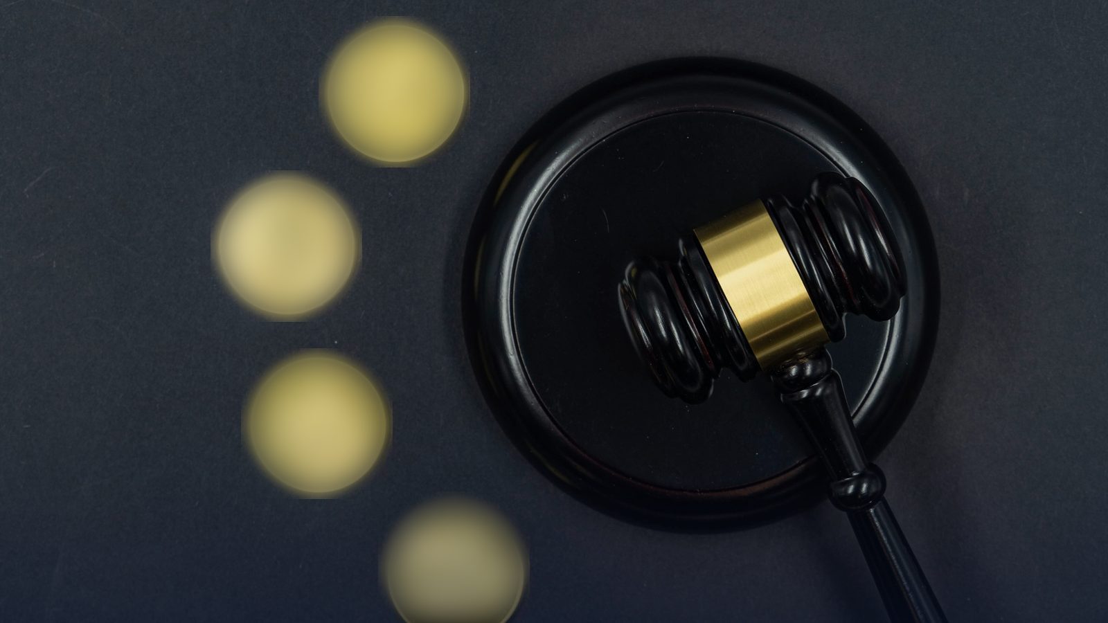 Cryptocurrency medallions next to a gavel