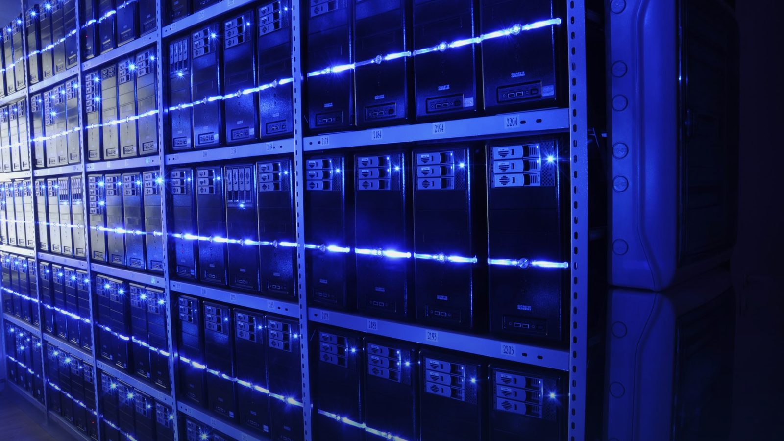Rows of servers in a data centre lit in blue