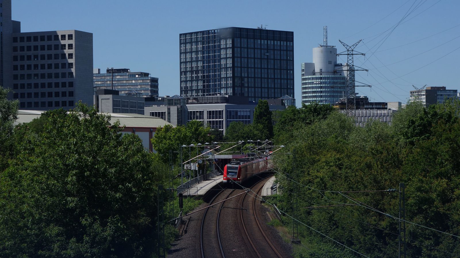 Office buildings in Eschborn, near Frankfurt, including The Cube, beside a railway line