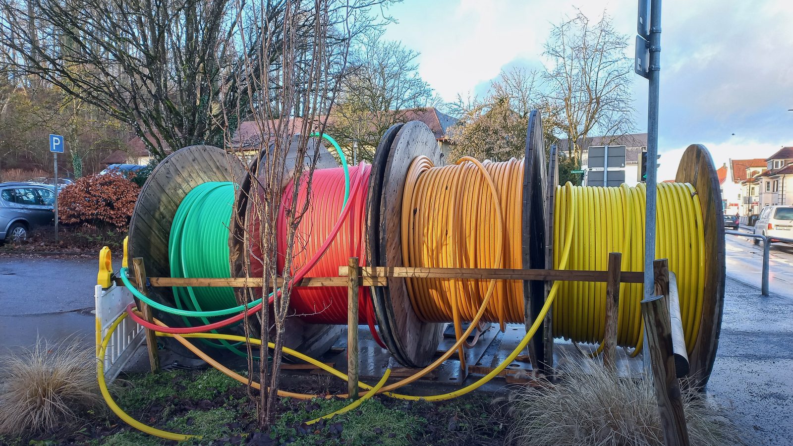 Reels of fibre-optic cable ducting at a street works site