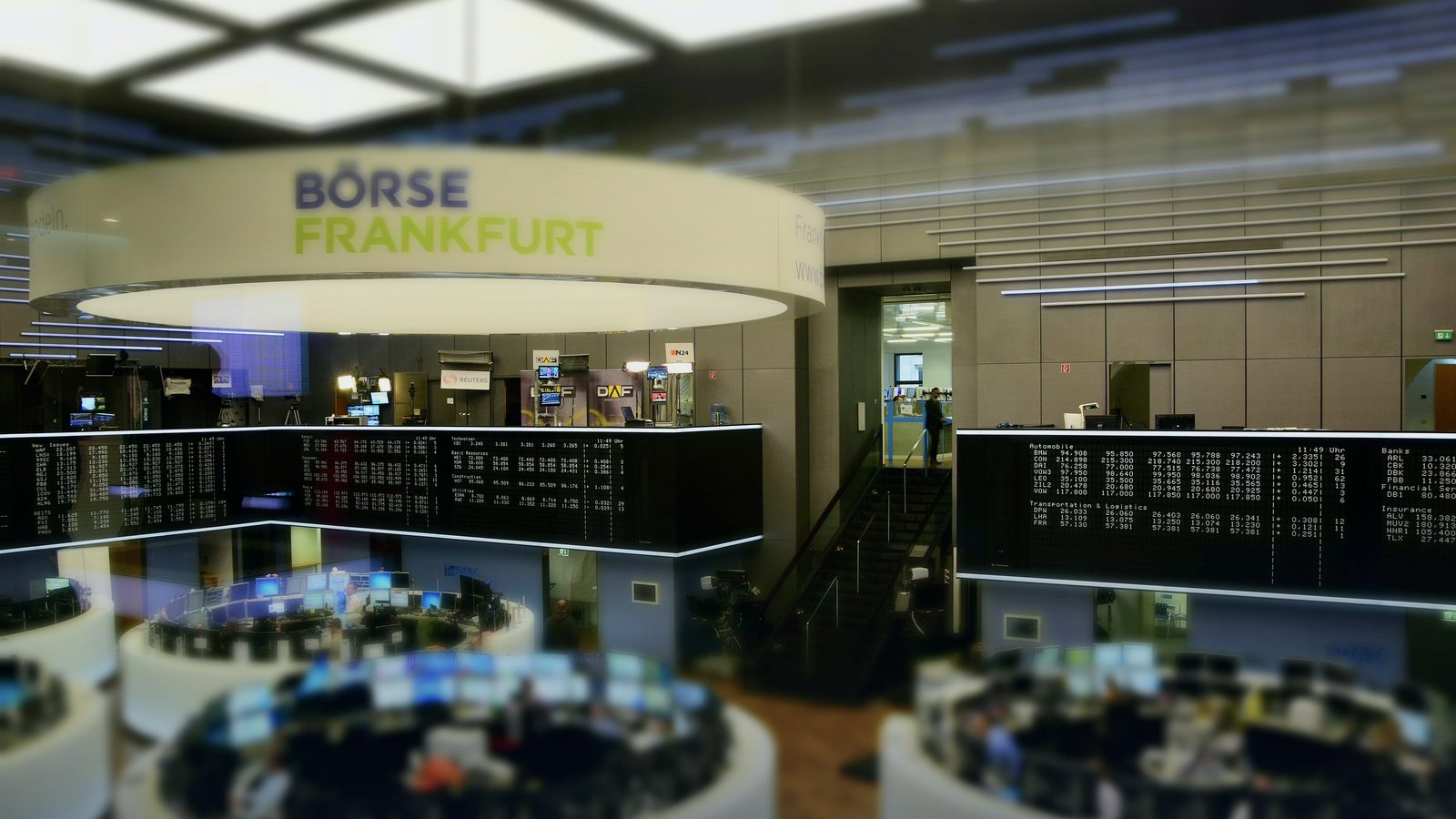 The trading floor of the Frankfurt Stock Exchange, with rows of desks under a large ticker display