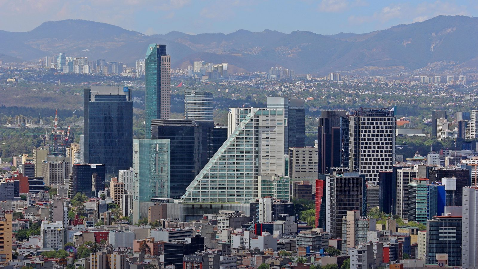 Towers along Paseo de la Reforma in Mexico City, with mountains behind