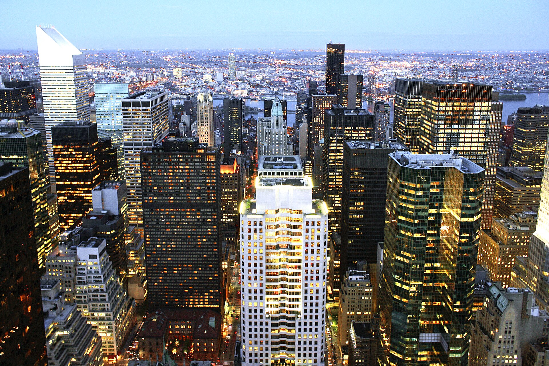 Office towers in East Midtown Manhattan lit up at dusk
