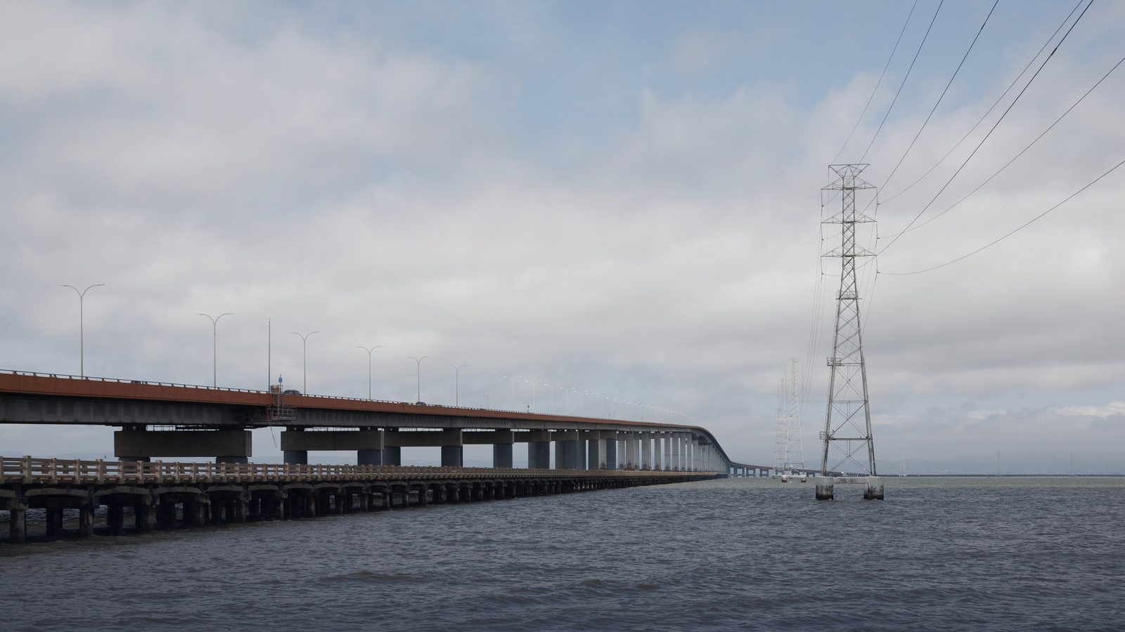 The San Mateo–Hayward Bridge crossing San Francisco Bay, with a transmission tower