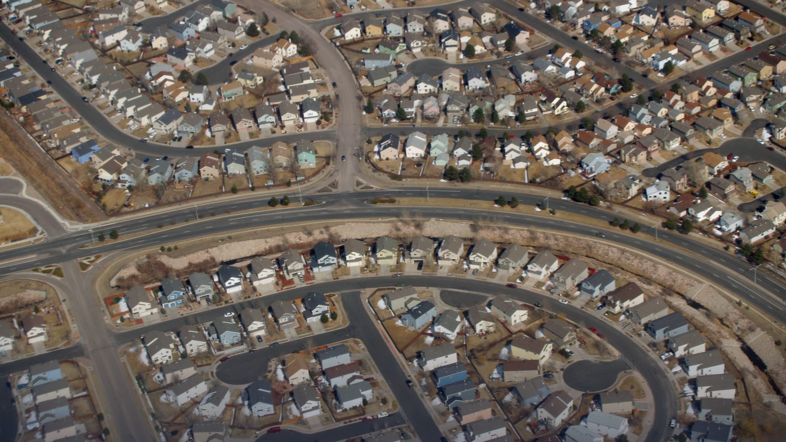 Aerial view of a suburban housing development with curving streets