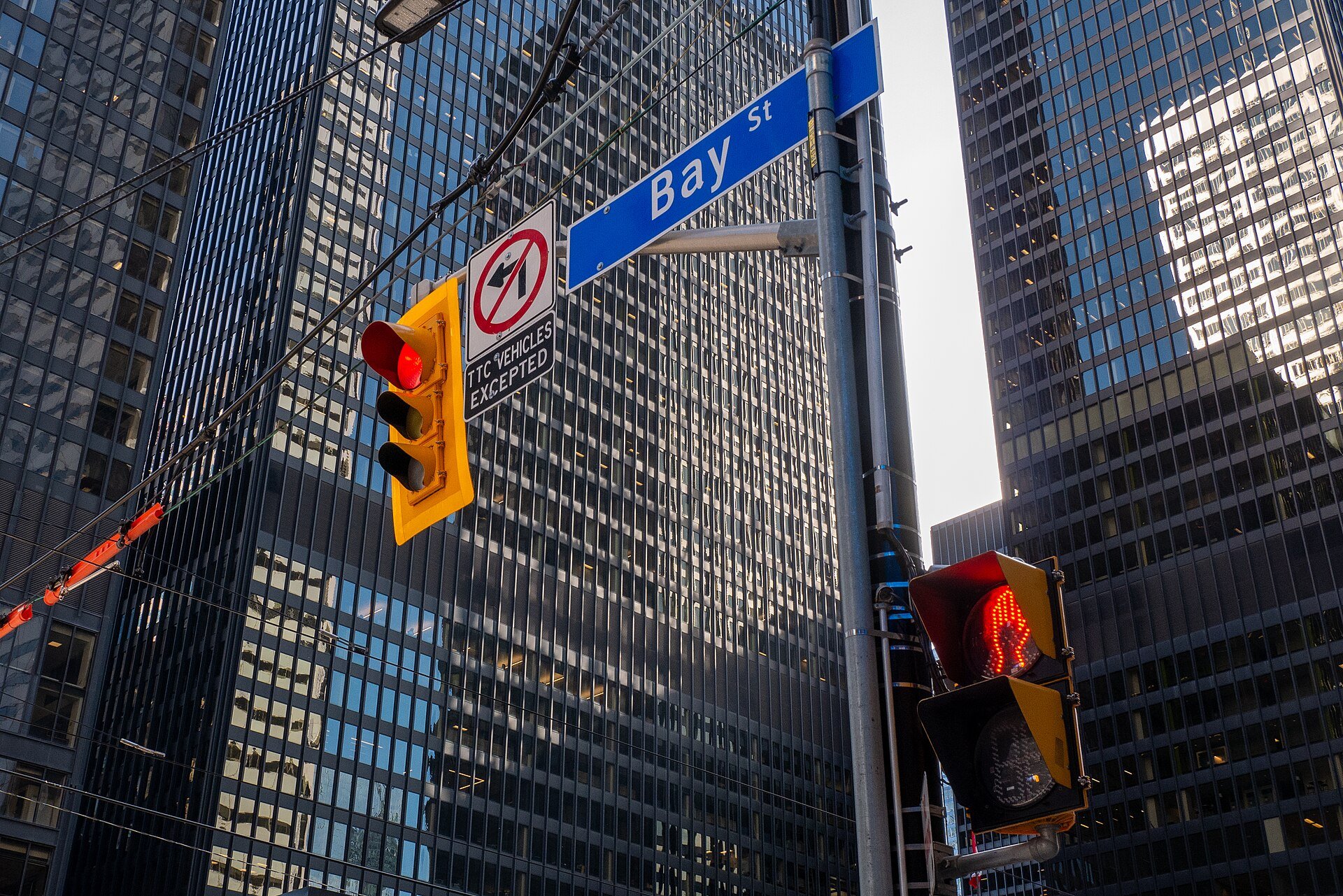 A Bay Street sign and traffic lights among office towers in Toronto's financial district